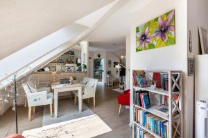 a dining room and living room with a table and chairs at Ferienwohnung Am Jakobsweg in Schmallenberg