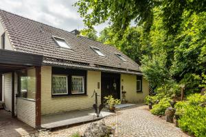 a yellow house with a walkway in front of it at Ferienwohnung Am Jakobsweg in Schmallenberg