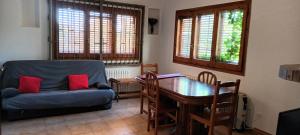 a living room with a blue couch and a table at Marina in Lleida