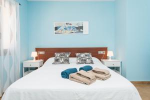 a bedroom with a white bed with towels on it at Can Fiol in Portocolom +31 photos