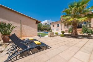a blue lawn chair sitting on a patio at Can Fiol in Portocolom