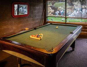 a pool table in a room with afits at The Lodge in Helen