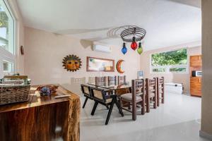 a kitchen and dining room with a table and chairs at Oceanfront home with beach access pool balconies & waterfront hammocks - Villa Sol in Tulum