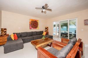 a living room with a couch and a table at Oceanfront home with beach access pool balconies & waterfront hammocks - Villa Sol in Tulum