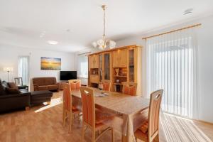 a dining room and living room with a table and chairs at Haus Langer in Oberkirch