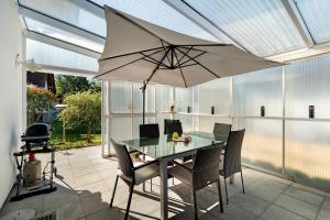 a table and chairs with an umbrella on a patio at Haus Langer in Oberkirch