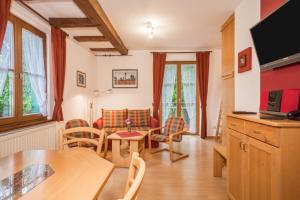 a living room with a table and chairs and a couch at Ferienwohnung Risthof 1 in Owingen