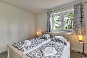 a bedroom with two beds and a window at Föhr in Galmsbüll