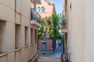 an alley between two buildings in a city at Cozy Apartment Blanes in Blanes