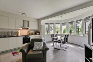 a kitchen and living room with a table and chairs at Föhr in Galmsbüll
