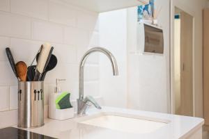 a kitchen counter with a sink and a sink at Cozy Apartment Blanes in Blanes +13 photos