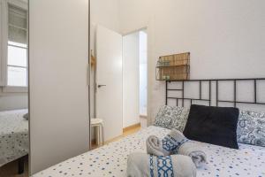 a bedroom with a bed and a mirror at Cozy Apartment Blanes in Blanes