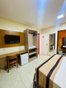 a hotel room with a bed and a desk and a sink at Boulevard Park Hotel in São Luís