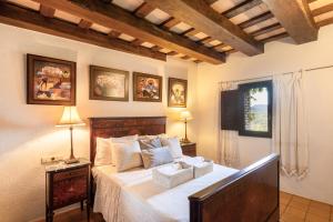 a bedroom with a bed with two lamps and a window at Casa Farigola in El Bruc +26 photos