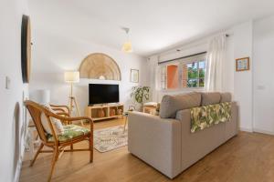 a living room with a couch and a tv at Atlantic Nomad Retreat in Puerto del Rosario