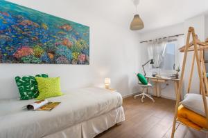 a bedroom with a large painting on the wall at Atlantic Nomad Retreat in Puerto del Rosario