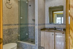 a bathroom with a shower and a toilet and a sink at Estudio P in L'Escala +13 photos