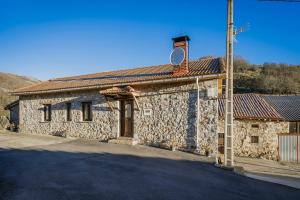 a stone building with a tower on top of it at Casa Lope in Dobres