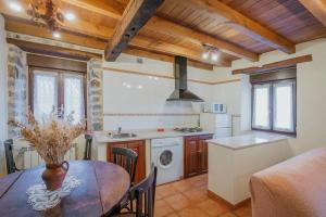a kitchen and dining room with a table and a stove at Casa Lope in Dobres +22 photos