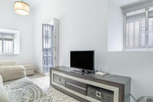 a living room with a flat screen tv on a fireplace at Casa Pepa in Barbate