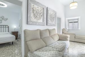 a living room with a couch and a bedroom at Casa Pepa in Barbate