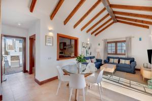 a living room with a table and a blue couch at Villa Turqué in Arrieta