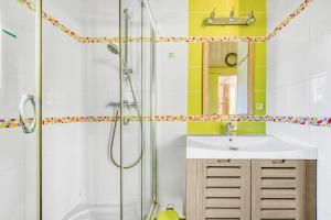 a bathroom with a sink and a shower at Joli Petit Chalet La Cote d'Argent in Le Porge