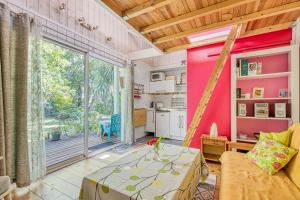 a living room with a couch and a table at Joli Petit Chalet La Cote d'Argent in Le Porge +17 photos