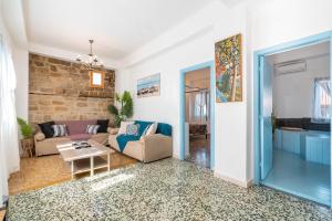 a living room with a couch and a table at Katia's Home in Rhodes Town