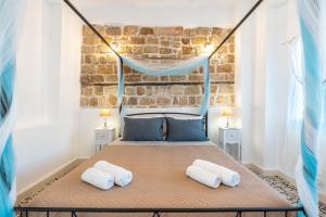 a bedroom with a bed with two pillows at Katia's Home in Rhodes Town
