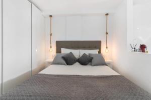 a bedroom with a large bed with two pillows at Los Molinos 202 in Maspalomas +12 photos