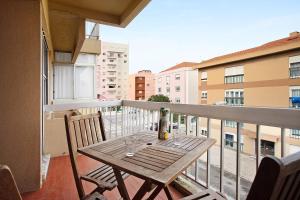 a table on a balcony with a bottle and glasses at A O - Apartamento Aires in Peniche