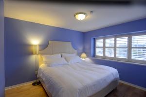 
a bedroom with a bed and a lamp in it at Marpole Guest House in Vancouver
