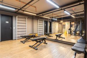 a gym with a row of exercise equipment and a mirror at APS - Alpha Stay By Anora Spaces in Barueri +14 photos