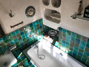 a man sitting in a bath tub in a bathroom at Maison à la campagne in Paley +17 photos