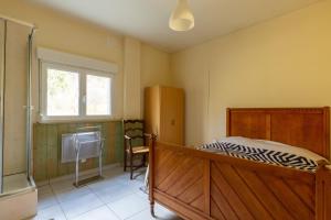 a bedroom with a bed and a desk and a window at Gite Du Dombief in La Chaux-du-Dombief +20 photos