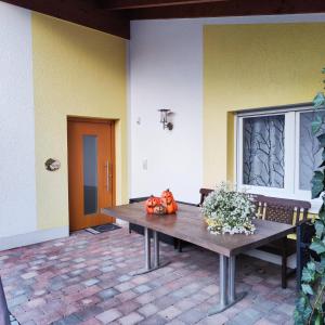 a table with pumpkins on it in a patio at Haus Pluto in Deggenhausertal