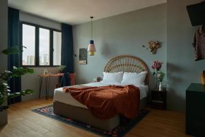 a bedroom with a bed with a blanket on it at House Rong in Singapore
