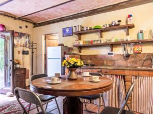 a kitchen with a table with chairs and a refrigerator at Apartment Ginestra by Interhome in Perugia +16 photos