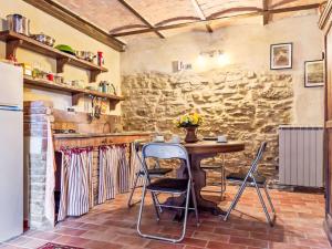 a kitchen with a table and two chairs at Apartment Ginestra by Interhome in Perugia
