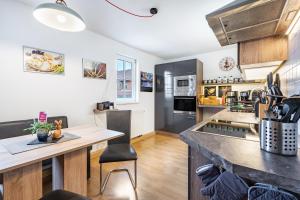 a kitchen with a large counter top and a table at Gohrischblick in Kurort Gohrisch