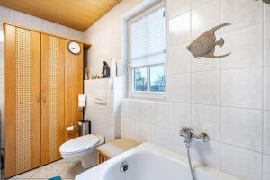 a bathroom with a tub and a toilet and a sink at Gohrischblick in Kurort Gohrisch +22 photos