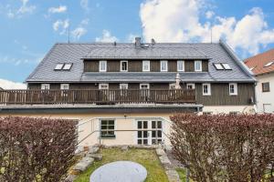 a large house with a deck on top of it at Gohrischblick in Kurort Gohrisch