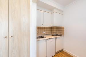 a kitchen with white cabinets and a counter top at Apartament Massanet 2b in Canyamel