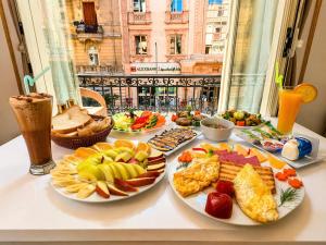 a table with many plates of food on it at Downtown Antique Hotel in Cairo