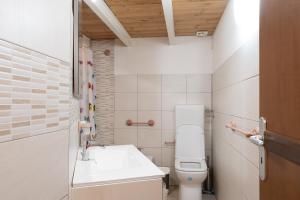 a small bathroom with a toilet and a sink at Seacastle Sicily in Castellammare del Golfo +17 photos