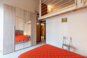 a bedroom with a bed and a red rug at Seacastle Sicily in Castellammare del Golfo