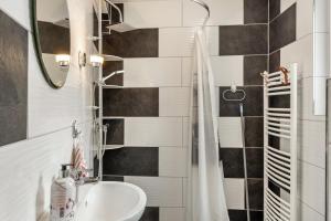 a bathroom with a sink and a shower at Ferienhaus Salzwedel in Salzwedel +16 photos