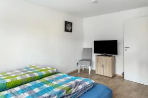 a bedroom with a bed and a flat screen tv at Ferienhaus Salzwedel in Salzwedel