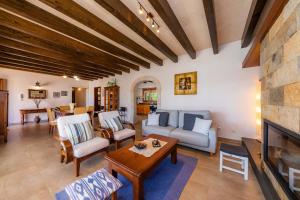 a living room filled with furniture and a fireplace at Finca Can Simonet in Santanyi